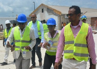 Jamaica's Tourism Minister, Hon. Edmund Bartlett (center) takes a tour of the construction of the artisan village at the Hampden Wharf in Falmouth.