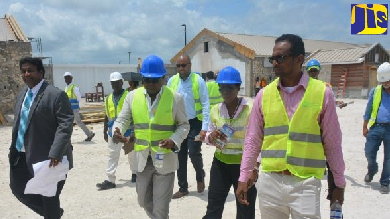 Jamaica's Tourism Minister, Hon. Edmund Bartlett (center) takes a tour of the construction of the artisan village at the Hampden Wharf in Falmouth.