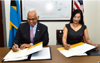 The Minister of Tourism, Hon. Dionisio D'Aguilar and Ms. Manisha Singh, US Assistant Secretary of State, Bureau of Economic and Business Affairs signing the Air Transport Agreement