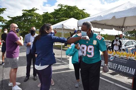 Commissioner Cohen Higgins and Miami Dolphins Senior Vice President Nat Moore