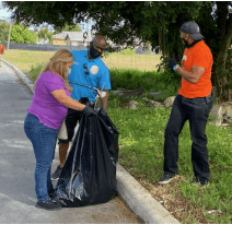 District 9 County Commissioner Kionne McGhee and staff help to clean up public areas in Florida City.
