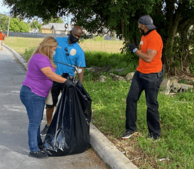 District 9 County Commissioner Kionne McGhee and staff help to clean up public areas in Florida City.